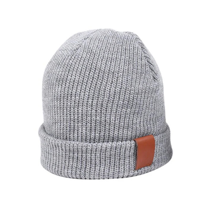 a grey knit hat with a brown leather band